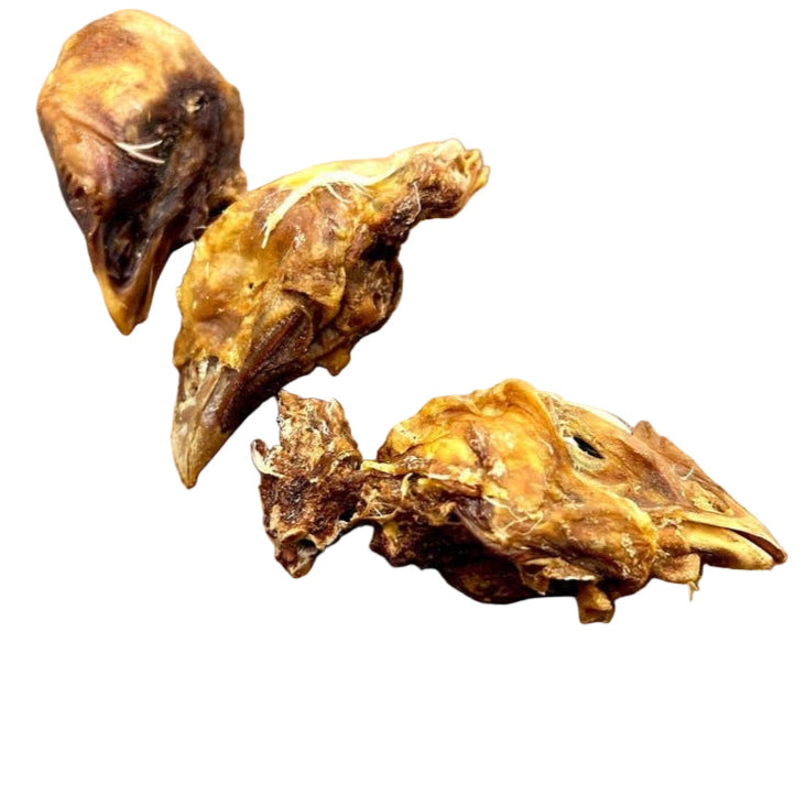 three dried chicken head dog treats